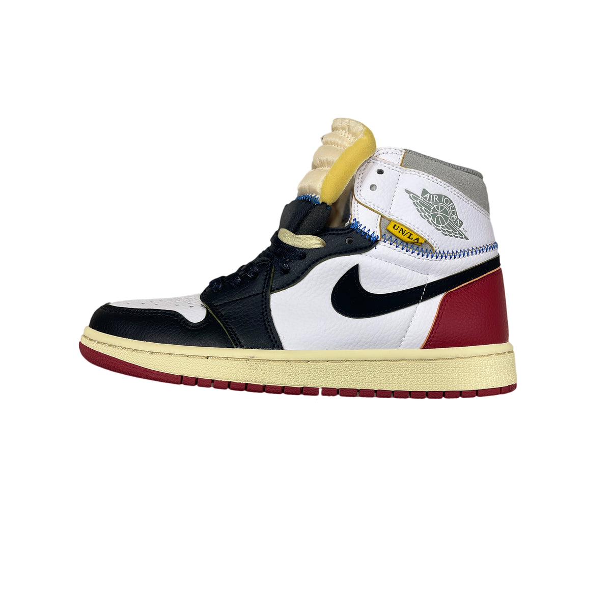 Air Jordan 1 Retro High Black Toe Union LA sneaker, black and white leather with deconstructed detailing, side profile view